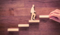 Ardian makes raft of senior promotions and additions to ASF management committee A person climbing steps, depicted with wooden blocks