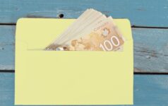 Canadian dollars in green envelope