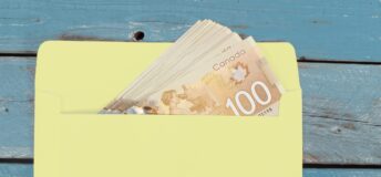 Canadian dollars in green envelope