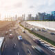 Busy road and city background during rush hour with motion-blurred vehicle, car in Singapore city highway. Modern buildings, office in background. Modern city, transportation background concept.