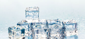 Square melting ice cubes on wet table