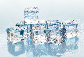 Square melting ice cubes on wet table