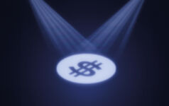 Dollar sign under spotlight