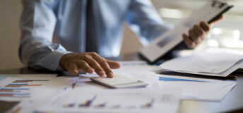Business accounting concept, Business man using calculator with computer laptop, budget and loan paper in office.
