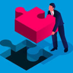 Person fitting a puzzle piece in its place.