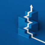 A white arrow painted on the blue floor climbs isometric steps