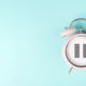 Alarm clock with pause sign, take a break, menopause concept, hormone replacement therapy