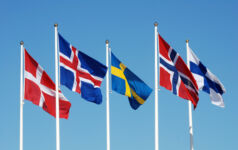 Scandinavian (most Nordic) flags on a blue sky.