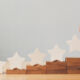 Top performing CVs continue to show outperformance over buyout funds โ Evercore Hand putting wooden five star shape on table. The best excellent business services rating customer experience concept.
