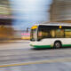 Bus driving on city street, motion blur, panning
